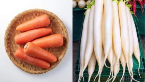 Fresh carrots and white radish displayed side by side, winter seasonal vegetables