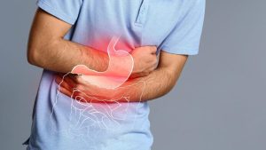 Person experiencing stomach pain due to digestive problems