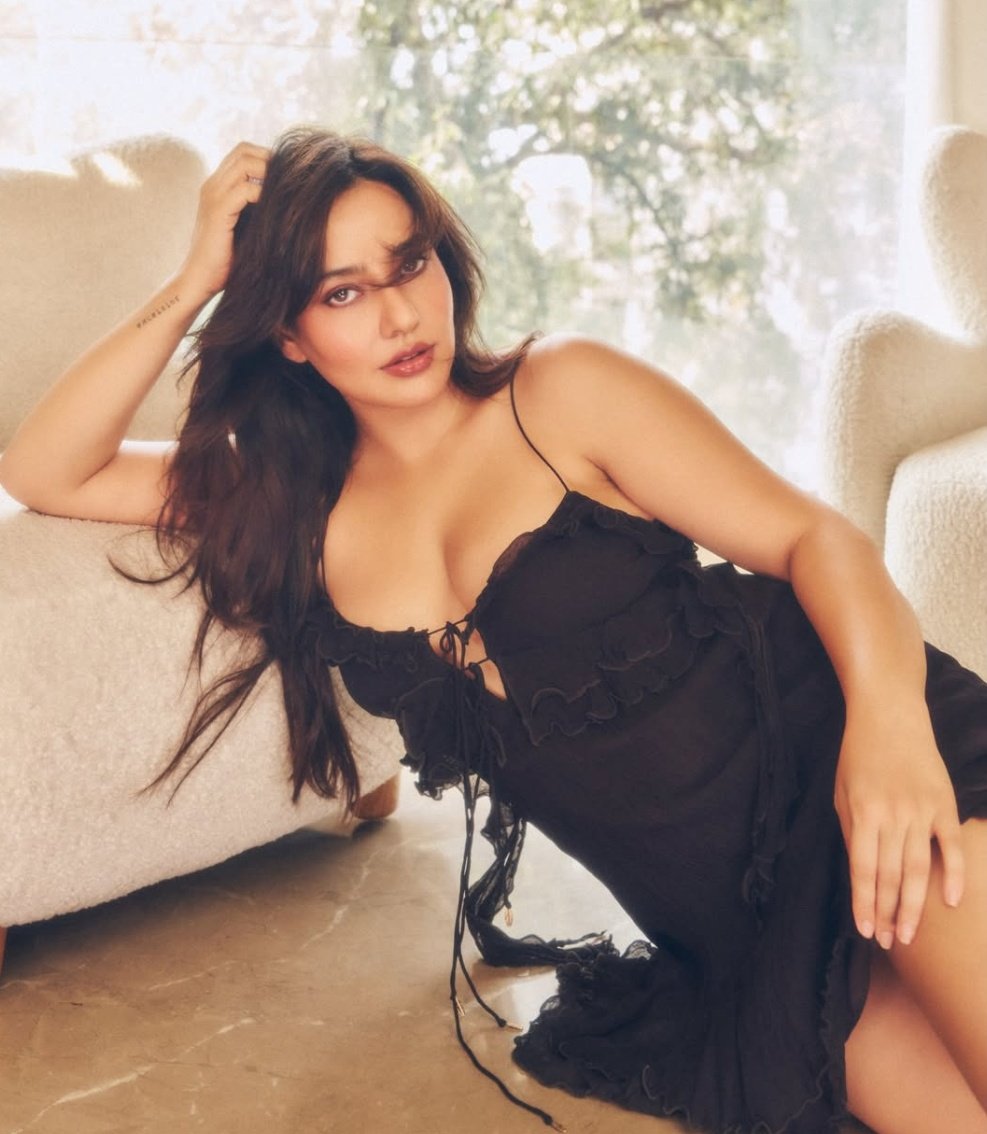 Neha Sharma elegant pose in black dress during a stylish photoshoot