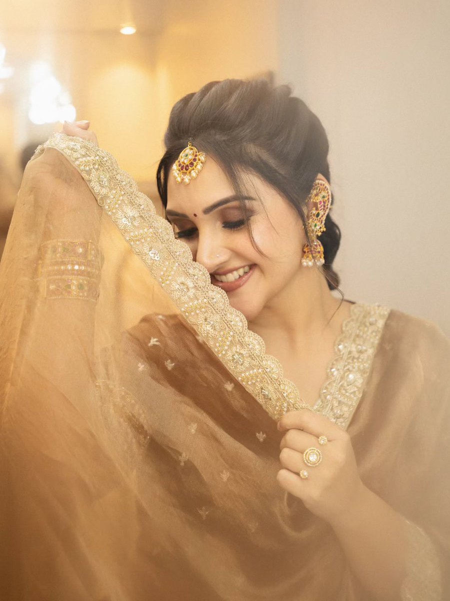 Sridevi wearing a golden net saree with traditional jewellery and a graceful smile