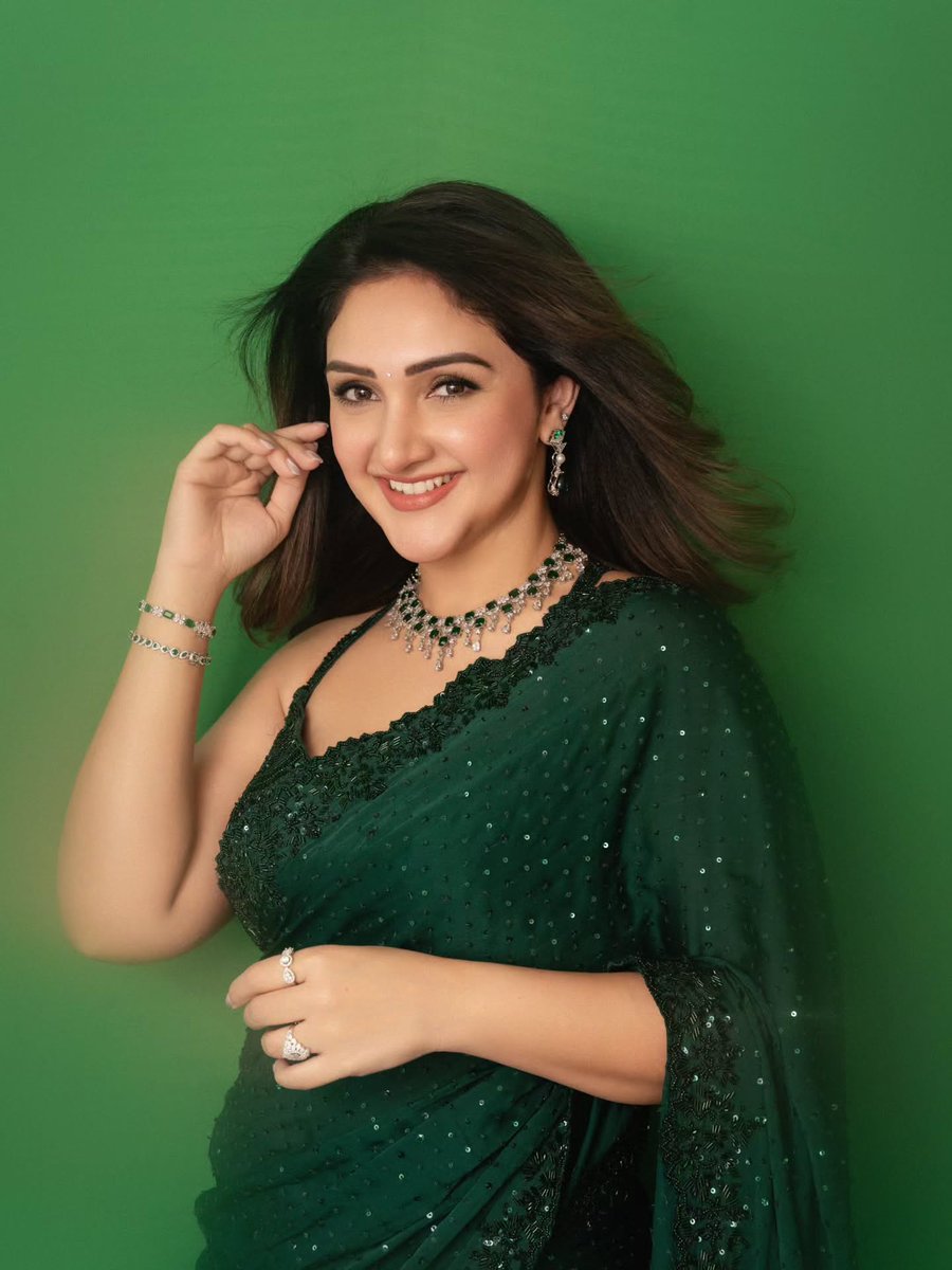 Sridevi posing gracefully in a green saree with an elegant smile