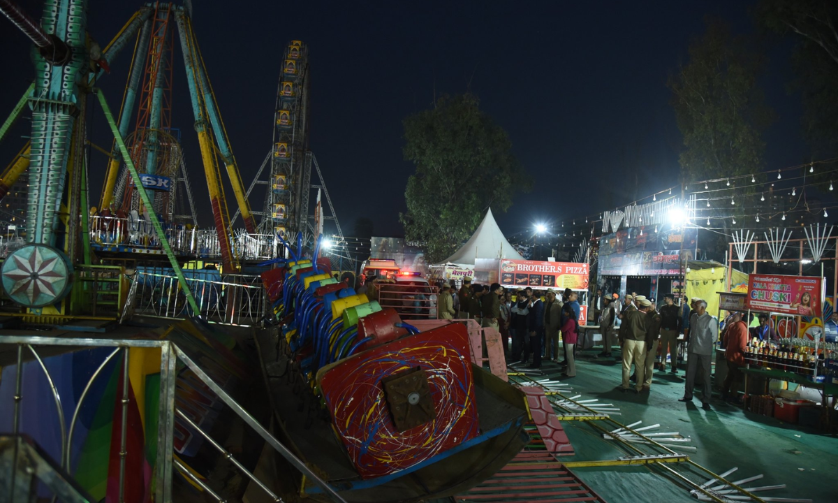 Collapsed joyride at Surajkund Mela in Faridabad with police and visitors at the accident site during night hours