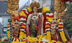Idols of Lord Venkateswara with Sridevi and Bhudevi beautifully decorated with colorful flower garlands and gold ornaments on a ceremonial platform