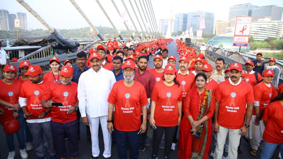 Health Minister Damodar Rajanarsimha and officials participating in a human chain for HIV/AIDS awareness on Hyderabad Cable Bridge