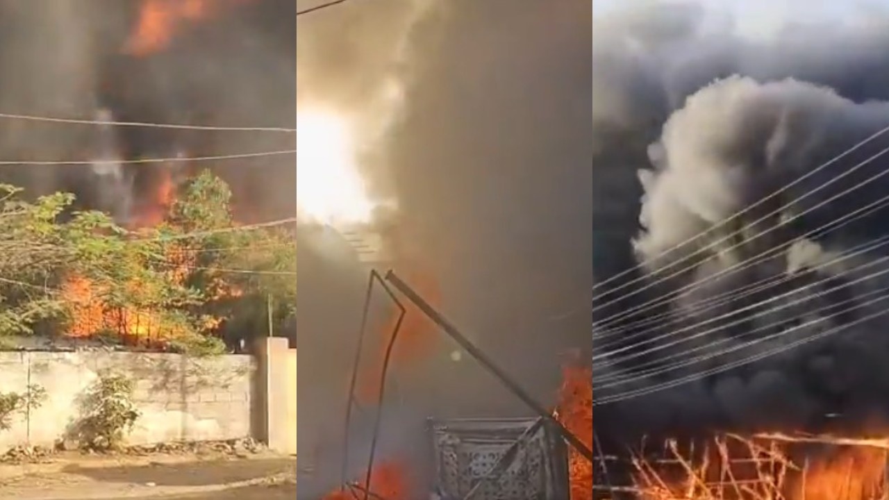 Firefighters dousing flames at a warehouse in Hyderabad amidst thick black smoke