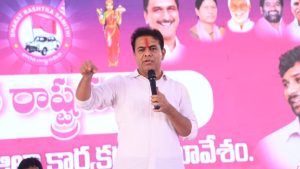 KTR speaking at BRS workers meeting in Mancherial, criticizing CM Revanth Reddy and Congress government's corruption.