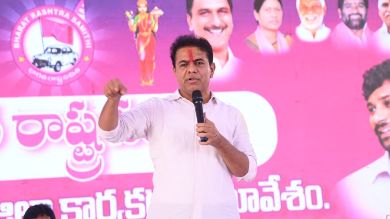 KTR speaking at BRS workers meeting in Mancherial, criticizing CM Revanth Reddy and Congress government's corruption.