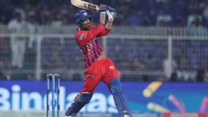 Young cricketer Mukul Choudhary playing a powerful shot for Lucknow Super Giants during IPL match against KKR.