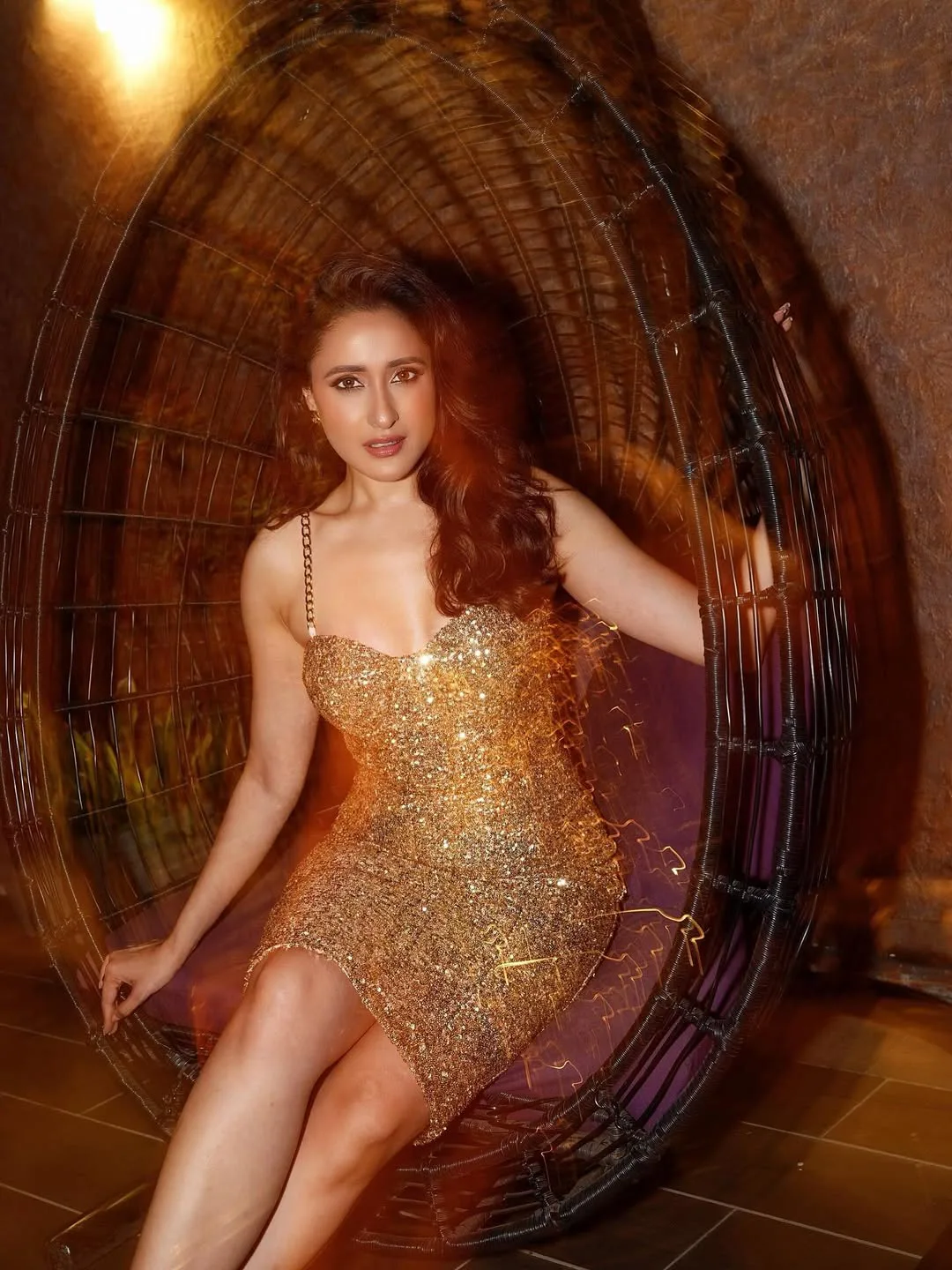 Star heroine Pragya Jaiswal in a gold color dress