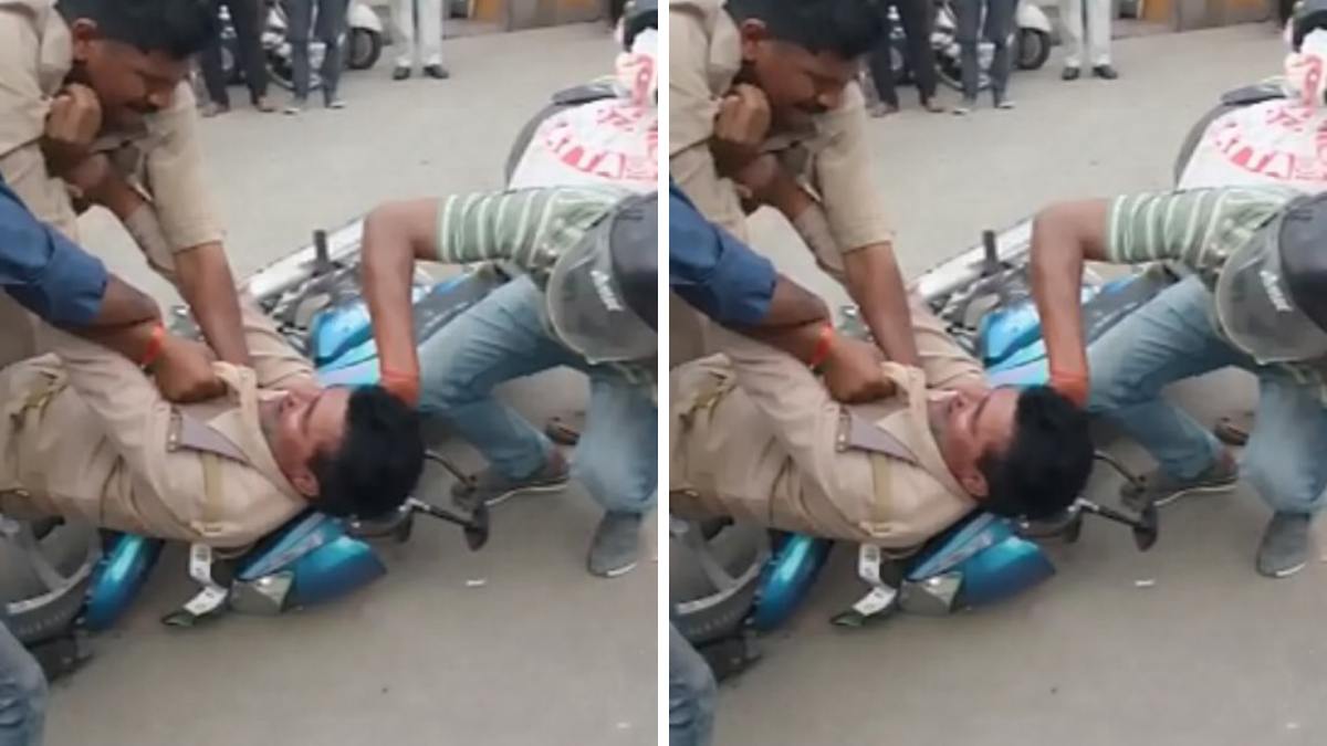 Two UP traffic police officers in uniform fighting on a busy road in Farrukhabad